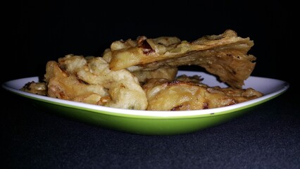 Close up shot of bakwan. Bakwan is a vegetable fritter or fried food that is commonly found in Indonesia. The ingredients use vegetables; bean sprouts, shredded cabbage and carrots, coated in batter.