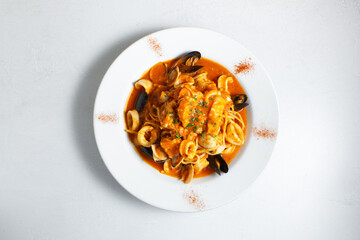A top down view of a plate of pasta pescatore.