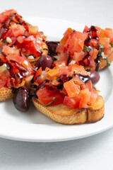 A closeup view of a plate of bruschetta.
