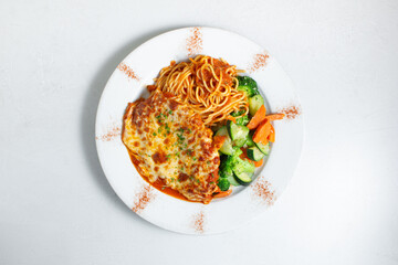 A top down view of a plate of chicken parmesan.