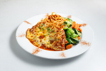 A view of a plate of chicken parmesan.