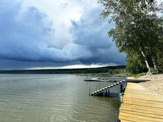 Picturesque Lakefront Scene with Wooden Docks and Overcast Sky