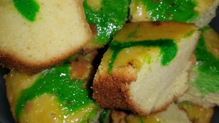 Close up shot of green patterned sponge cake that has been cut.