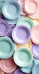 Pastel-colored plates in a variety of patterns and designs, stacked and layered