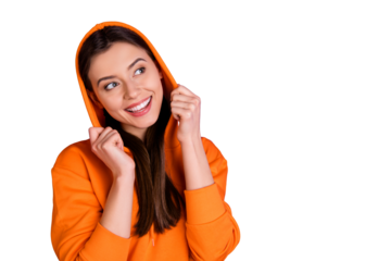 Portrait of positive cheerful teenager girl wear her hood think about her weekends enjoy thoughts feel content wear orange youth teen clothes isolated over bright color background