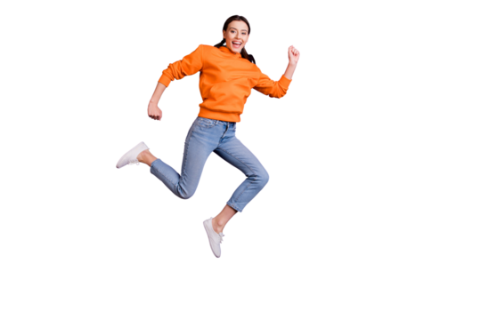 Full body photo of positive cheerful youth girl jump run after discounts feel content wear sportswear denim jeans white sneakers isolated over violet purple color background - Powered by Adobe