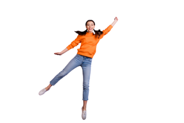 Full size photo of positive cheerful teen girl hold hand jump catch her flying parasol on windy weather wear orange sporty outfit jeans white sneakers isolated over violet purple color background