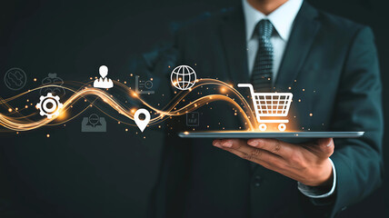 Businessman using digital tablet for online shopping with glowing icons representing e-commerce and technology