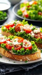 Two open-faced sandwiches topped with lettuce, cherry tomatoes, feta cheese, and parsley