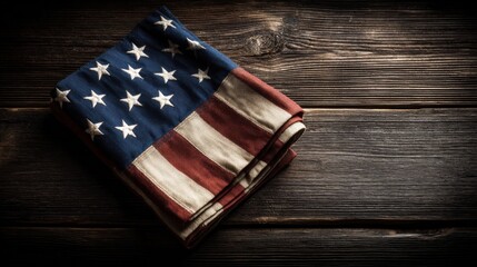 Obraz premium Patriotic Fabric Folded on Rustic Wood Surface, Symbolizing American Heritage and National Holiday