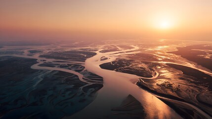 Bird flying over river delta sunrise with intricate water channels and tidal patterns visible perfect for aerial photography themes drone footage covers and environmental awareness campaigns