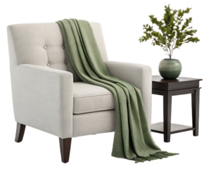 Armchair with green throw blanket and side table with plant on white background studio shot