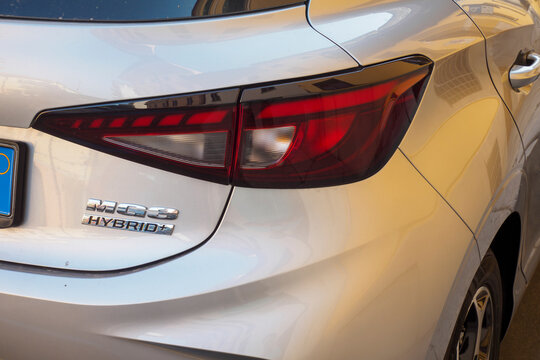Close up of the rear light of a silver MG3 Hybrid plus parked on a city street, showcasing its modern design and hybrid technology