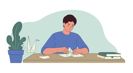 Man creating origami, with crane & books by table plant, soft colors