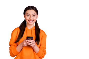 Portrait of lovely positive cheerful youth girl addicted blogger use her mobile phone share post blogs on her social network account wear sportswear isolated over violet purple color background