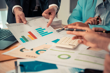 Meetings for business presentations or seminars Such documents contain financial or marketing figures, graphs, and charts. There are laptops and digital tablets on the table, close-up image.