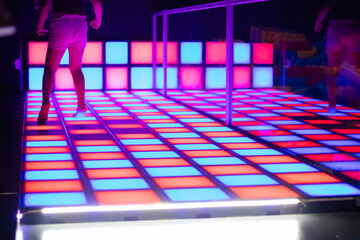 Vibrant illuminated dance floor with colorful tiles