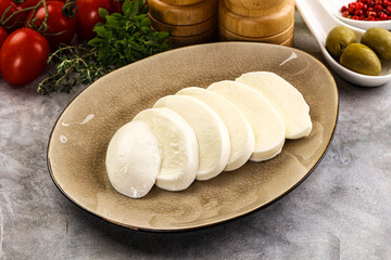 Organic mozzarella cheese slices in the plate