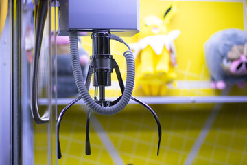 Close-up of claw machine with plush toys