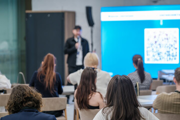 Audience attentively listening to a speaker during a professional seminar in a conference hall