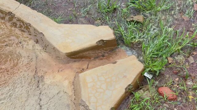Closeup of a water stream coming from a gushing borewell with a strong ground water source