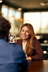 Smiling Woman Enjoying a Conversation in a Warm, Casual Indoor Setting