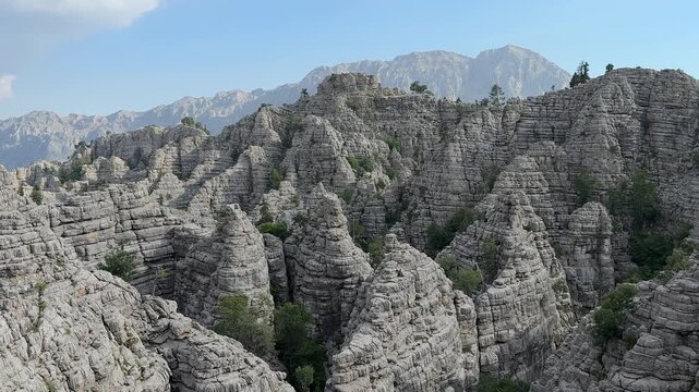 Unusual rock structures of wild mountains, deep pits, dolines and creative formations