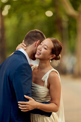 Fototapeta premium Couple Embracing During Romantic Wedding Day in Outdoor Natural Setting