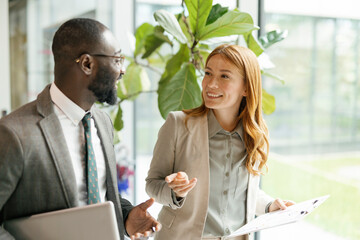 Professionals discussing work and strategy during business meeting in office