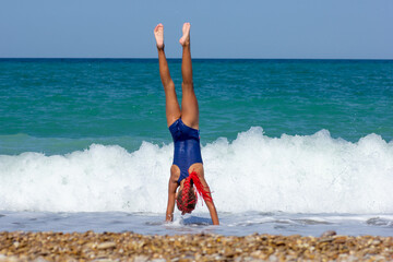 Girl Doing a Handstand on the Beach