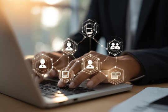 Businessman working on laptop with digital network icons overlay