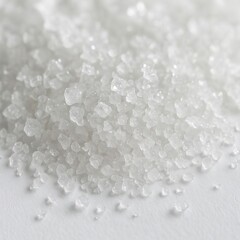Close-up macro view of coarse salt crystals texture on white surface
