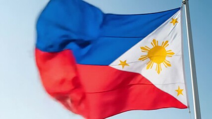 Symbol of Filipino pride and freedom, the Philippine flag waves against a clear sky.