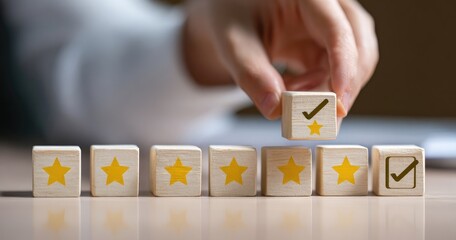 Hand placing a wooden block with a check mark on top of a row of star-shaped blocks