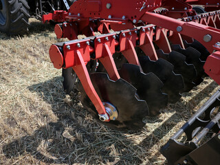 Close-up of a large modern plow or disc harrow for cultivating the land.