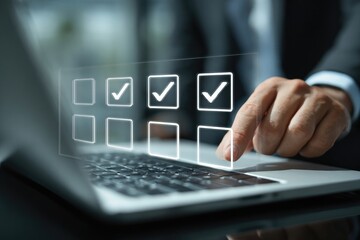 Businessman using laptop, checking boxes on a virtual checklist