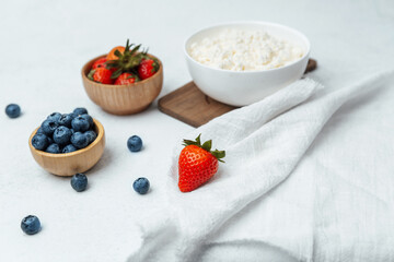 Fresh fruits and cottage cheese displayed on a white table setting