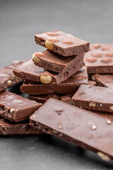 Chocolate cupcake with icing and chocolate bar in Dark lighting,Homemade delicious chocolate muffin on wooden background close-up