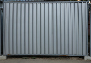 grey backdrop. beige gray silver Corrugated metal wall fence  background and texture surface or...