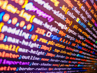 Computer code background. Colorful programming source typed on the screen of the monitor with shallow focus effect. Modern technology and futuristic concept abstract visualization of software. 
