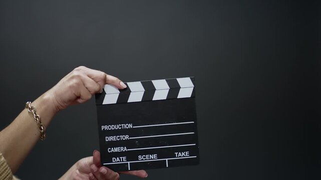 Hands holding a movie clapperboard ready for a film production scene