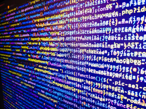 Shallow depth of field, selective focus effect. Javascript code in bracket software. Programmer typing new lines of HTML code. Notebook closeup photo. Project managers work new idea
