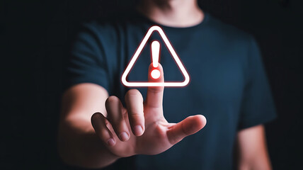 Person touching a glowing digital warning sign with an exclamation mark in a triangle on a dark background