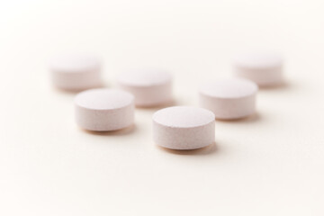 Creatine tablets on paper background. Soft focus. Close up. Copy space	