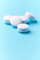 Creatine tablets on paper background. Soft focus. Close up. Copy space	