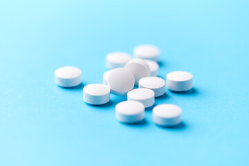 Hyaluronic acid tablets. Hyaluronic acid helps skin stretch and flex and reduces skin wrinkles. Bright paper background. Soft focus. Close up. Copy space