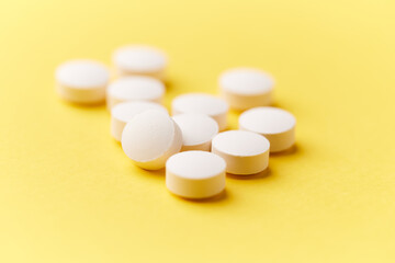 Creatine capsules on paper background. Soft focus. Close up. Copy space.	