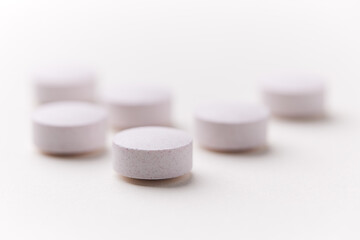 Creatine capsules on paper background. Soft focus. Close up. Copy space.	
