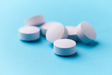 Creatine capsules on paper background. Soft focus. Close up. Copy space.	