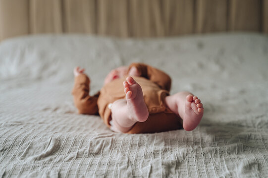 Peaceful newborn baby lying comfortably in bed